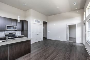 A kitchen with dark wood cabinets and a white countertop.